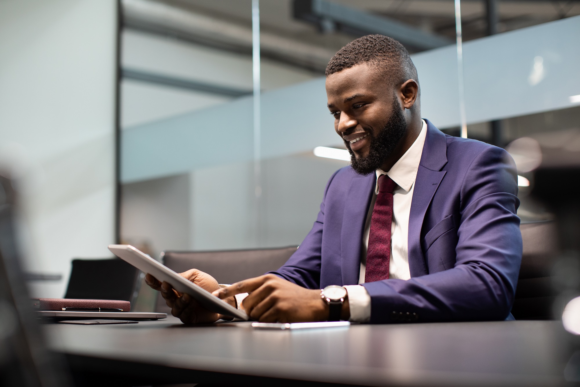 Cheerful black guy CEO working at office